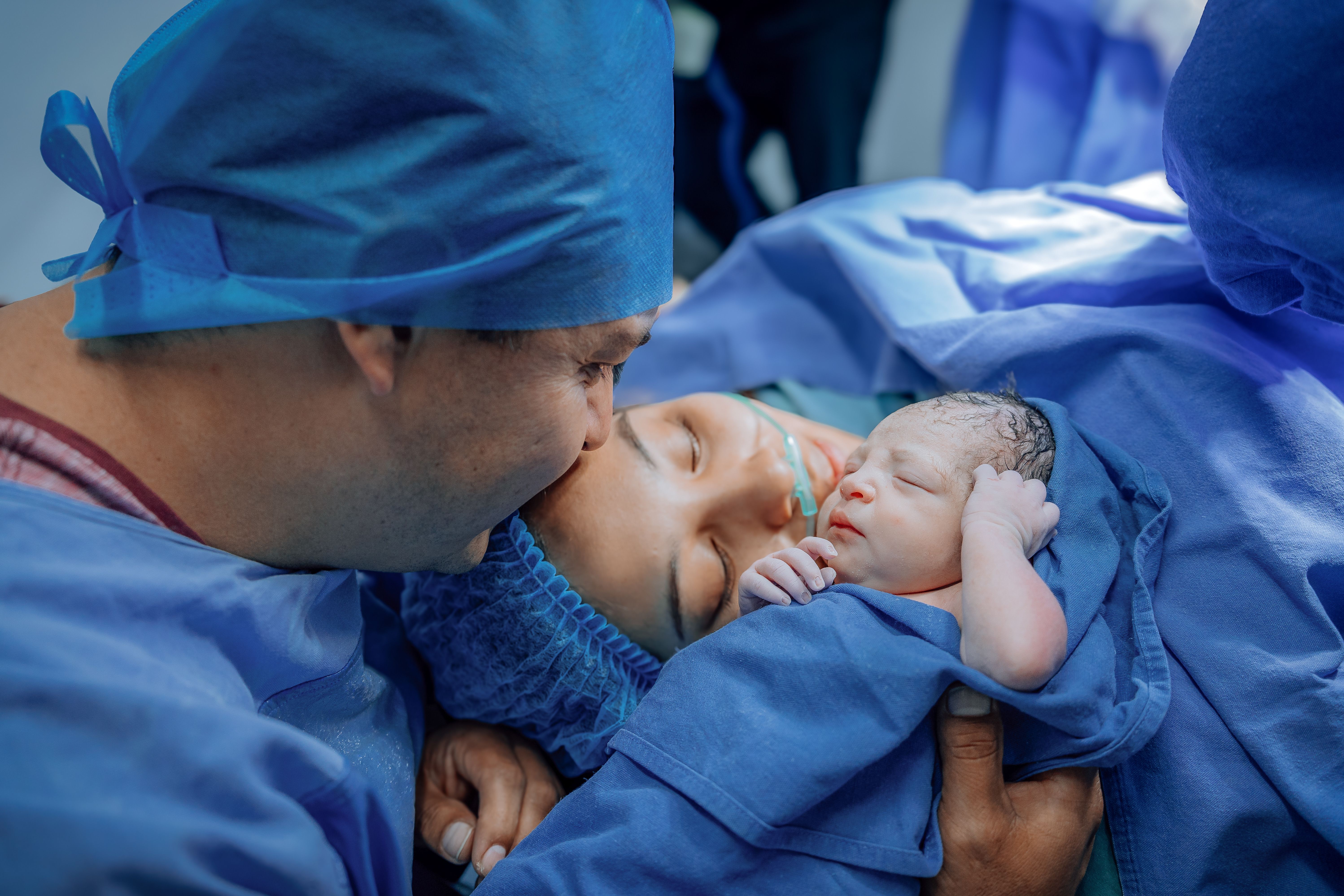New parents with their newborn in a birthing suite